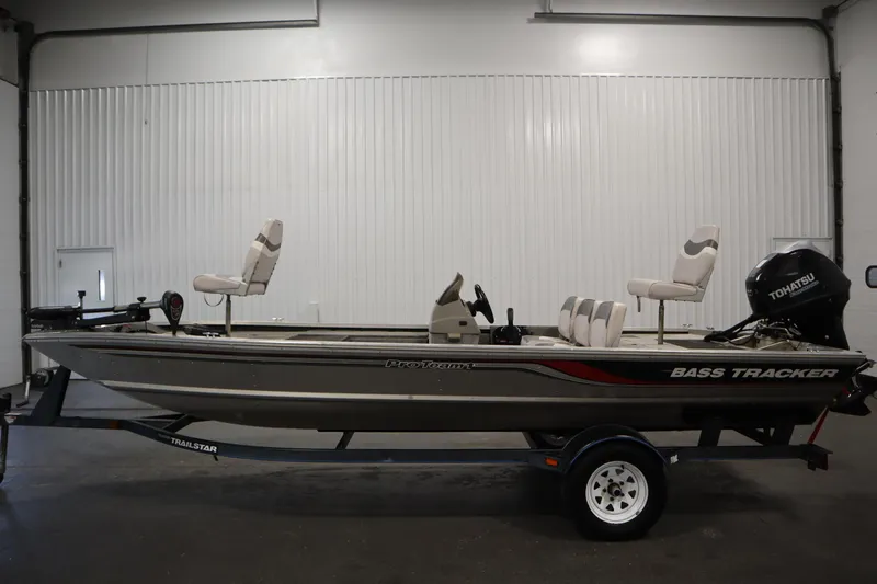 Slide: The Image of 1997 Tracker 18 Pro Team SC fishing boat with Tohatsu motor in indoor setting. - 8