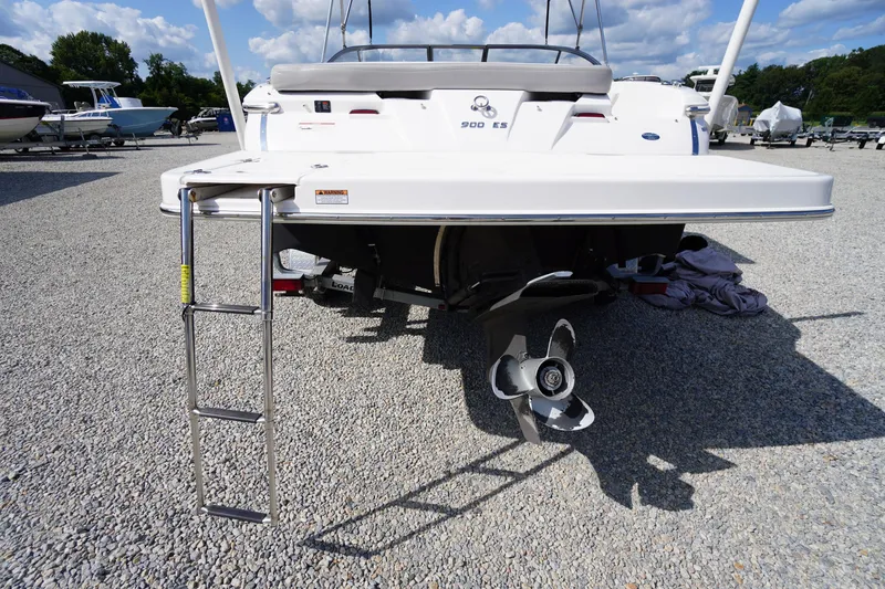 Slide: The Image of 2019 Regal 1900 ES Bowrider boat with ladder and propeller, parked on gravel. - 24