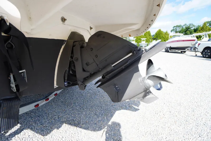 Slide: The Image of 2019 Regal 1900 ES Bowrider boat propeller and stern detail on gravel. - 27