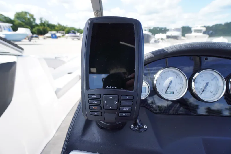 Slide: The Image of Garmin device on 2019 Regal 1900 ES Bowrider dashboard with gauges in background. - 7