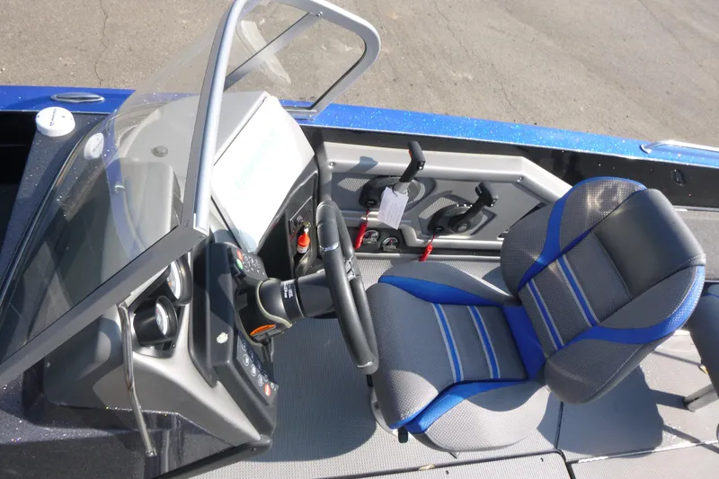 Slide: The Image of 2024 Ranger 621FS Pro boat cockpit with steering wheel and blue-gray seat. - 6