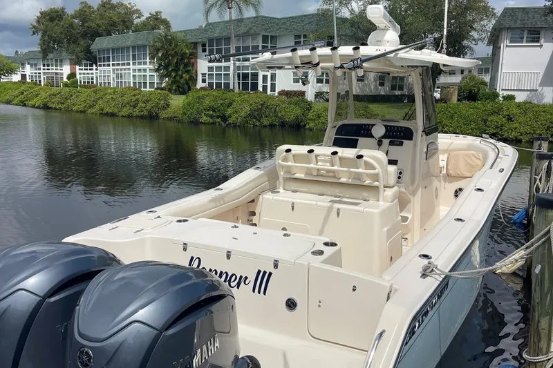 Slide: The Image of 2022 Grady-White Canyon 271 boat docked by waterfront homes. - 1