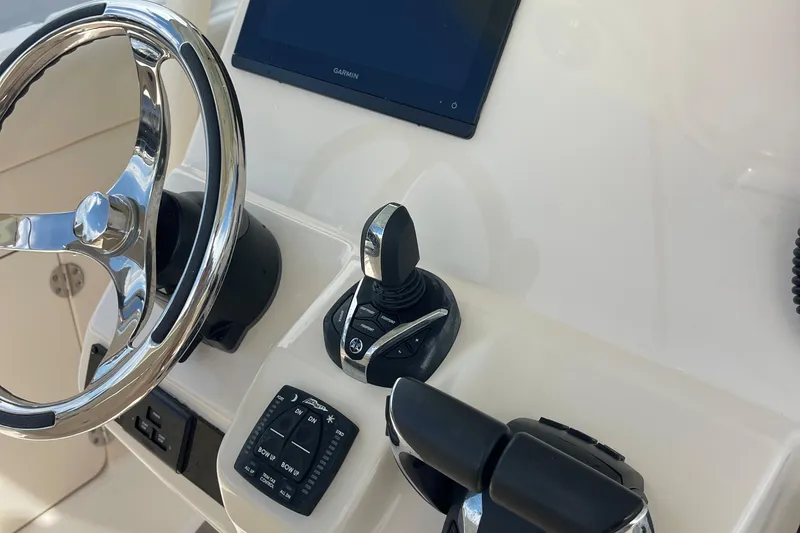 Slide: The Image of Steering console of 2022 Grady-White Canyon 271 boat with controls and display. - 10