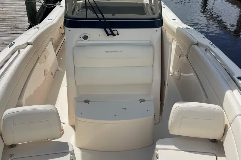 Slide: The Image of 2022 Grady-White Canyon 271 boat interior with white seating and console. - 19