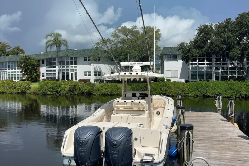 Slide: The Image of 2022 Grady-White Canyon 271 boat docked by waterfront homes. - 2