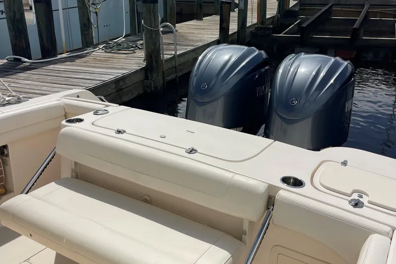 Slide: The Image of 2022 Grady-White Canyon 271 boat with twin outboard engines at dock. - 21