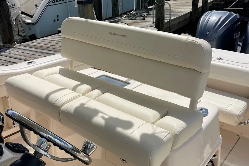 Slide: The Image of 2022 Grady-White Canyon 271 boat with cream leather seating and steering wheel. - 22