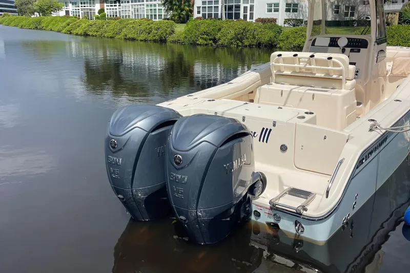 Slide: The Image of 2022 Grady-White Canyon 271 boat with twin Yamaha outboard engines docked on calm water. - 4