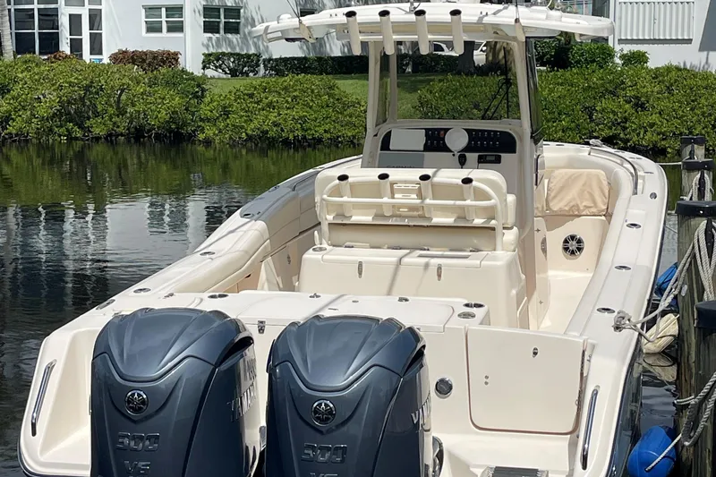 Slide: The Image of 2022 Grady-White Canyon 271 boat with dual Yamaha engines docked by waterfront. - 5