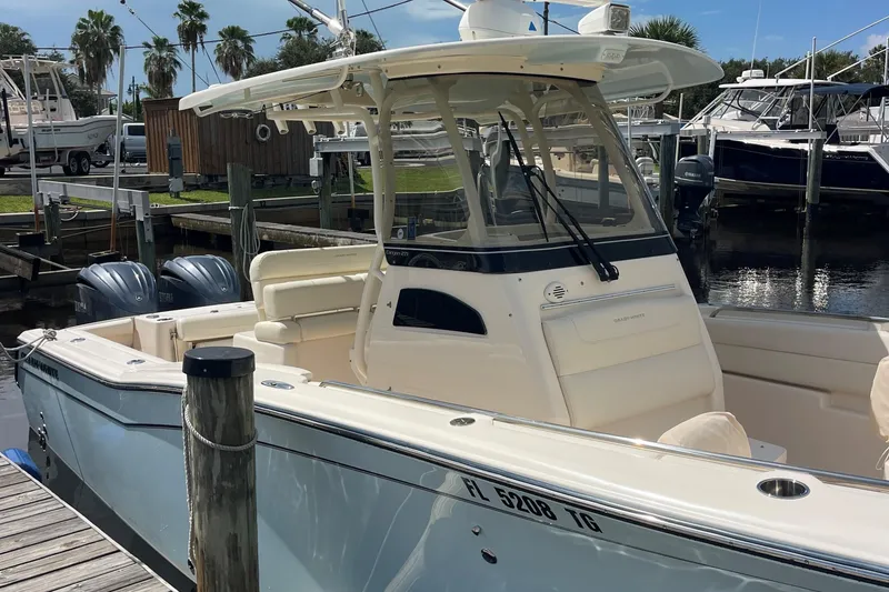 Slide: The Image of 2022 Grady-White Canyon 271 boat docked at marina with twin engines. - 6