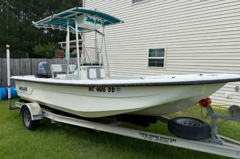 Slide: The Image of 2006 Sundance B20CC/CX boat on trailer, parked beside a house. - 0