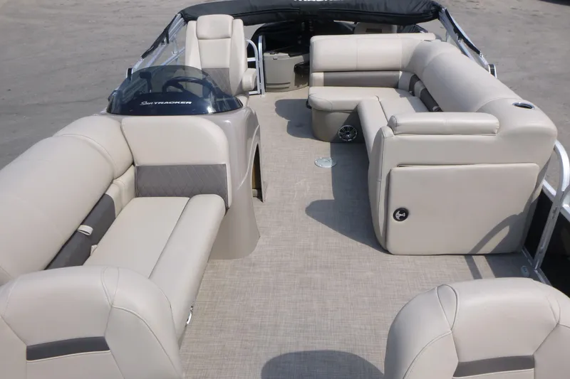 Slide: The Image of 2022 Sun Tracker Fishin' Barge 20 DLX interior with beige seating and spacious layout. - 5