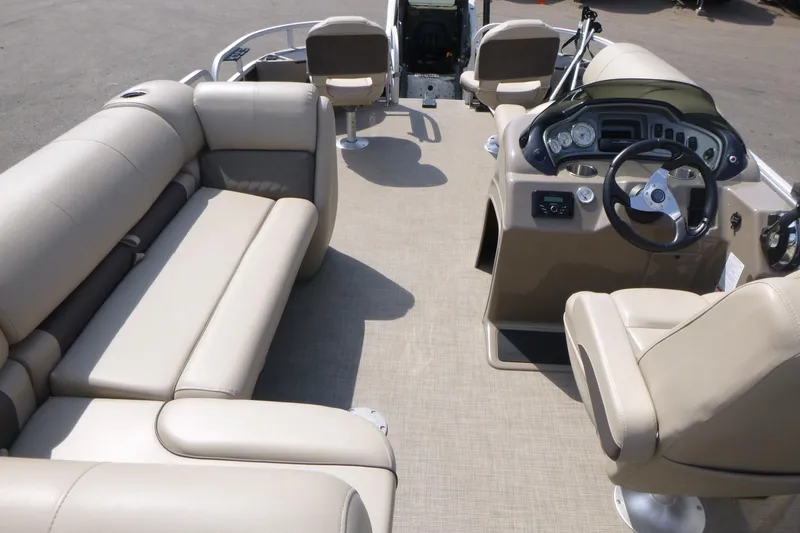 Slide: The Image of 2022 Sun Tracker Fishin' Barge 20 DLX interior with beige seating and steering console. - 6