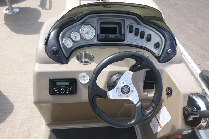 Slide: The Image of 2022 Sun Tracker Fishin' Barge 20 DLX dashboard with steering wheel and gauges. - 8