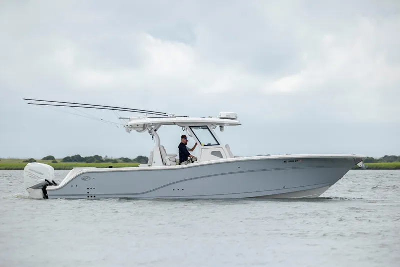Slide: The Image of 2022 Sea Fox 368 Commander boat on water, side view, with fishing rods. - 1