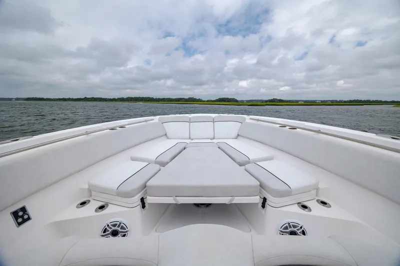 Slide: The Image of 2022 Sea Fox 368 Commander boat interior with cushioned seating on open water. - 10