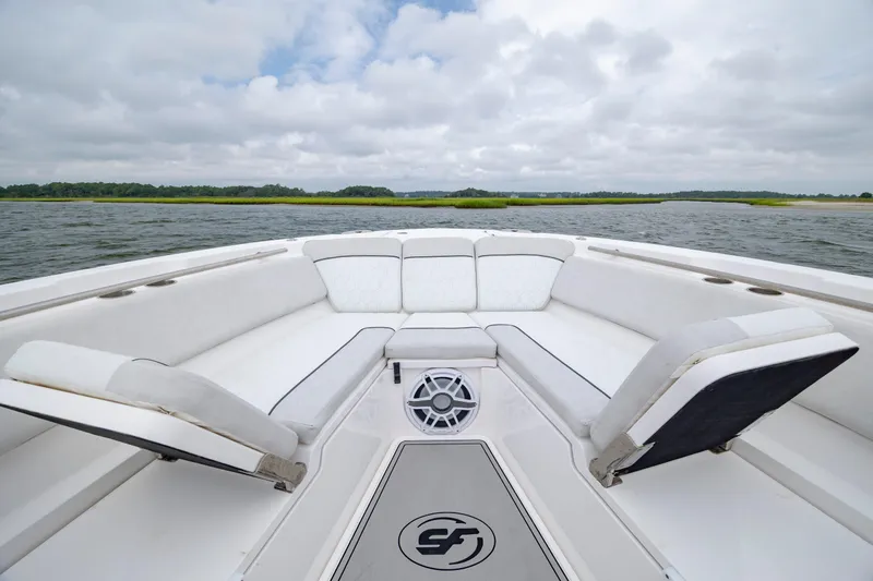Slide: The Image of 2022 Sea Fox 368 Commander boat interior with cushioned seating and scenic water view. - 11