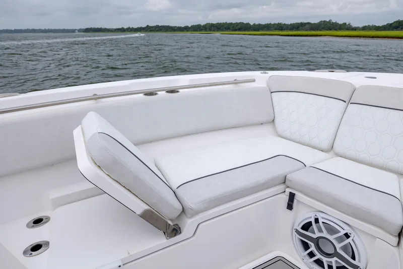 Slide: The Image of 2022 Sea Fox 368 Commander boat interior with white cushioned seating and speaker. - 12