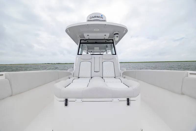 Slide: The Image of 2022 Sea Fox 368 Commander boat interior with cushioned seating on open water. - 15