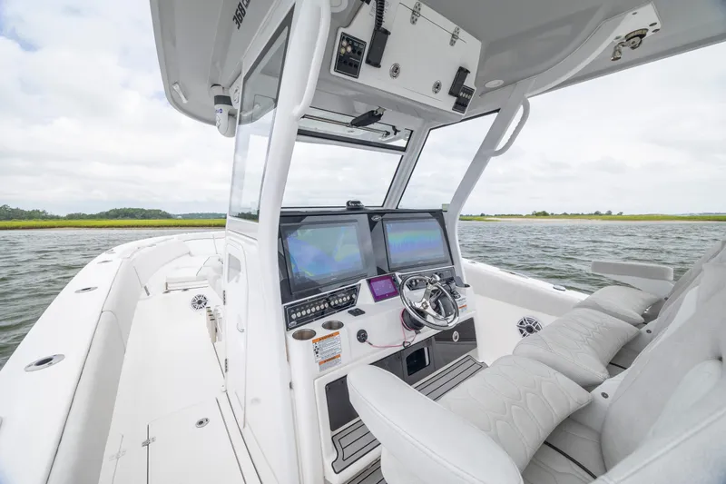 Slide: The Image of 2022 Sea Fox 368 Commander boat interior with modern helm and dual screens on open water. - 20