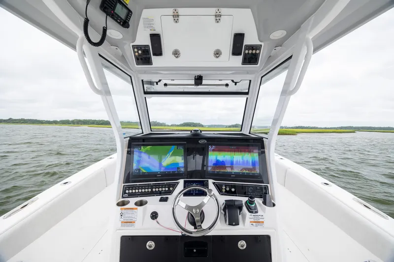 Slide: The Image of 2022 Sea Fox 368 Commander helm with advanced navigation displays on open water. - 21