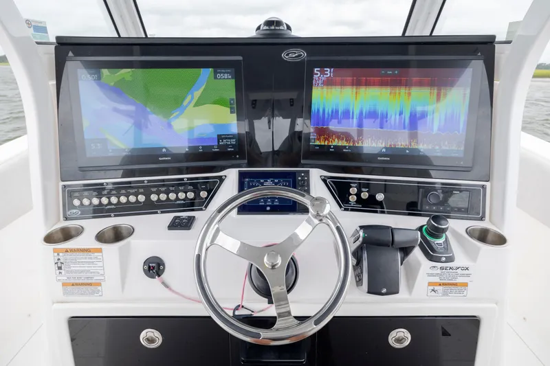 Slide: The Image of Cockpit of 2022 Sea Fox 368 Commander with dual Garmin displays and steering wheel. - 22