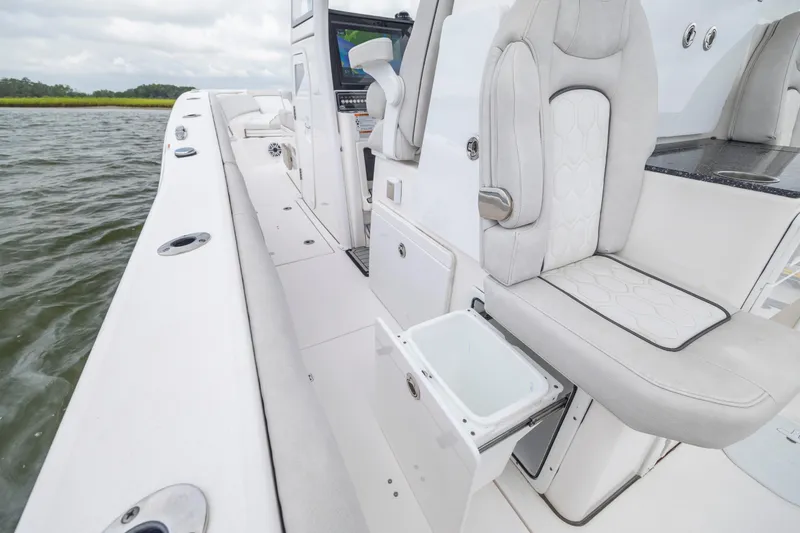 Slide: The Image of 2022 Sea Fox 368 Commander boat interior with luxurious seating and storage on the water. - 27