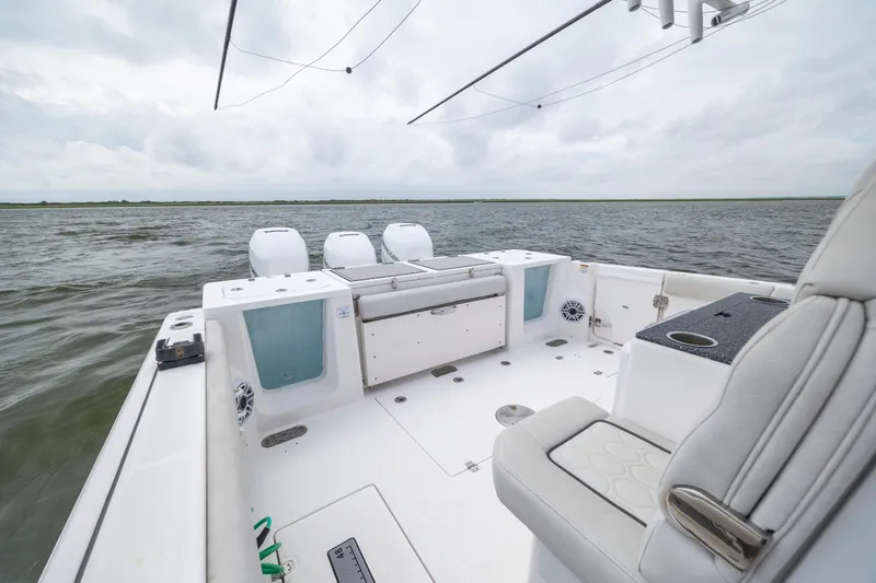 Slide: The Image of 2022 Sea Fox 368 Commander boat interior with ocean view, featuring seating and storage. - 28