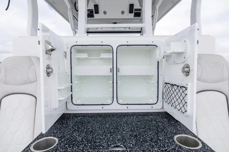 Slide: The Image of 2022 Sea Fox 368 Commander boat storage compartments with open doors and seating. - 29