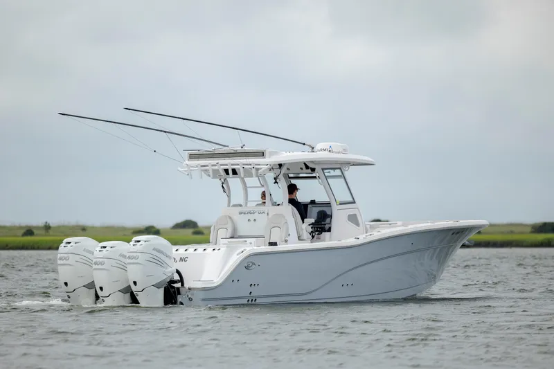 Slide: The Image of 2022 Sea Fox 368 Commander boat cruising on water with triple outboard engines. - 3