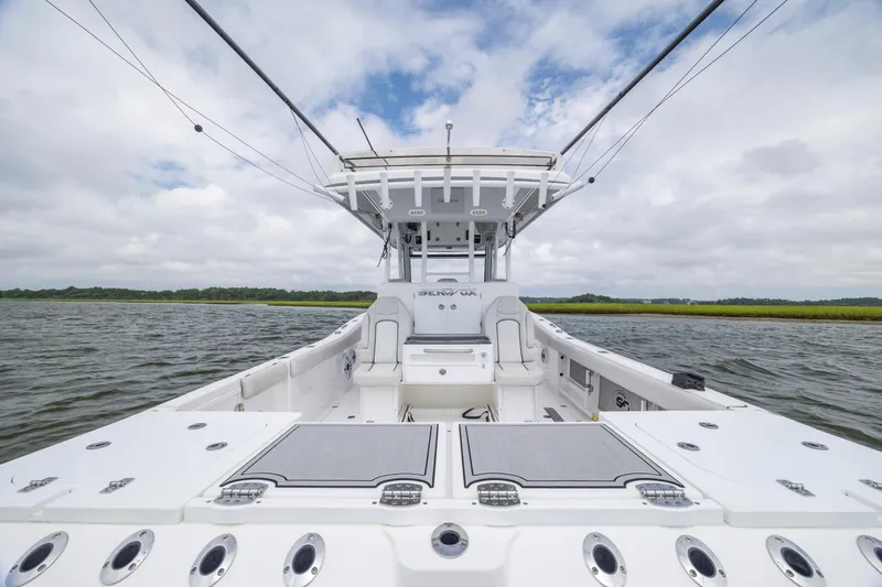 Slide: The Image of 2022 Sea Fox 368 Commander boat on water, showcasing spacious deck and seating. - 30