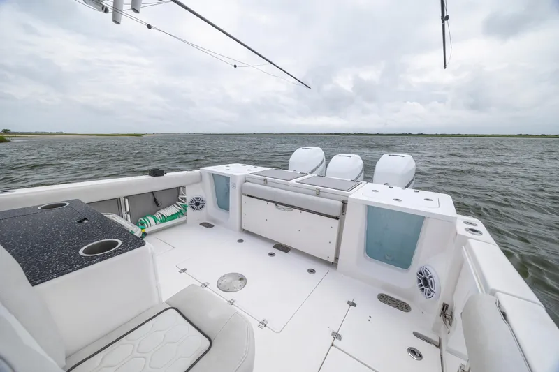 Slide: The Image of 2022 Sea Fox 368 Commander boat interior with triple outboard motors on open water. - 31