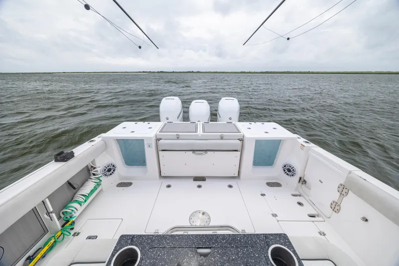 Slide: The Image of 2022 Sea Fox 368 Commander boat deck with triple engines on open water. - 32