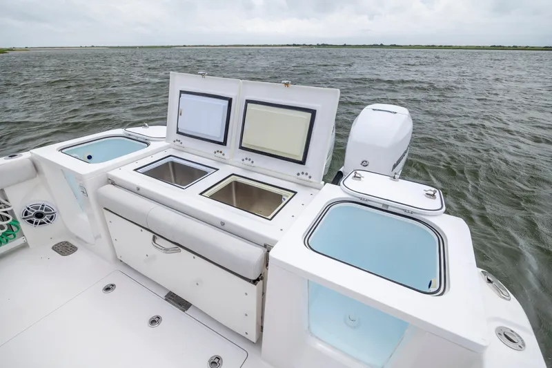 Slide: The Image of 2022 Sea Fox 368 Commander boat with open storage compartments on a calm sea. - 34