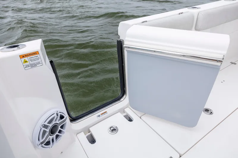 Slide: The Image of 2022 Sea Fox 368 Commander boat with open side door and speaker, on water. - 36