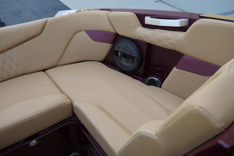 Slide: The Image of 2023 MasterCraft XT20 boat interior with tan upholstery and built-in speaker. - 10