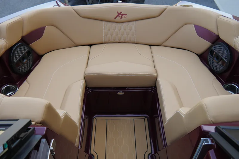 Slide: The Image of 2023 MasterCraft XT20 boat interior with beige seating and integrated speakers. - 11