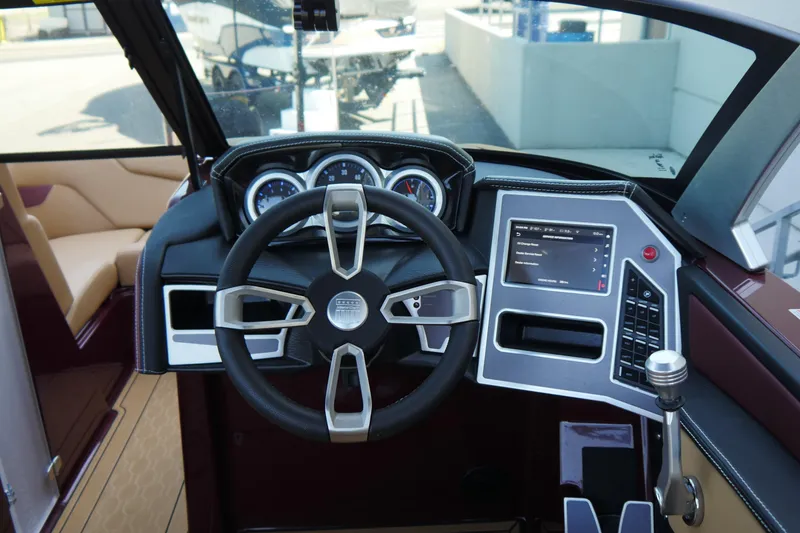 Slide: The Image of 2023 MasterCraft XT20 boat dashboard with steering wheel and digital display. - 12