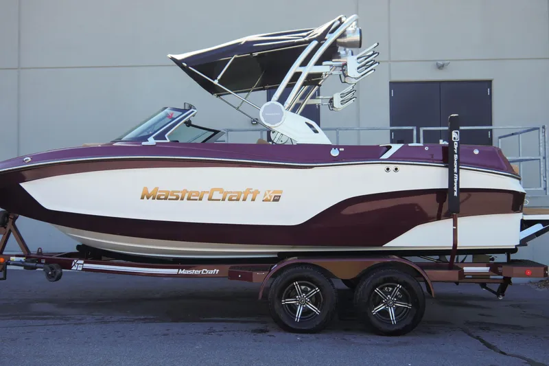 Slide: The Image of 2023 MasterCraft XT20 boat on trailer, featuring sleek design and modern wakeboard tower. - 3