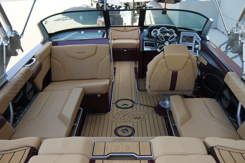 Slide: The Image of 2023 MasterCraft XT20 boat interior with luxurious tan seating and modern dashboard. - 6