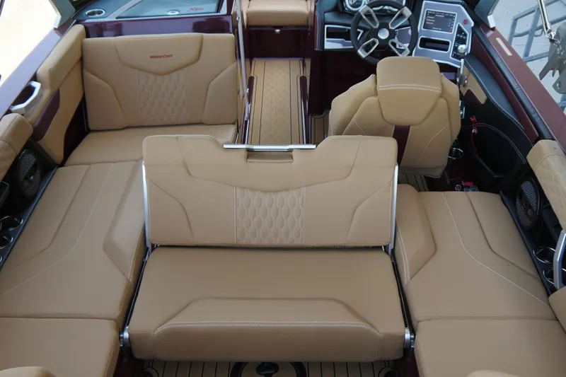 Slide: The Image of 2023 MasterCraft XT20 boat interior with luxurious tan seating and modern dashboard. - 7