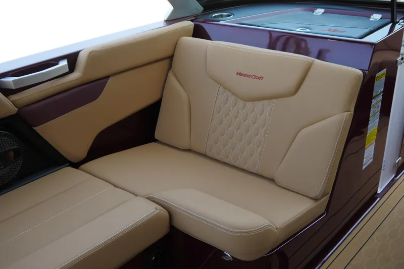 Slide: The Image of 2023 MasterCraft XT20 interior with tan leather seating and maroon accents. - 8