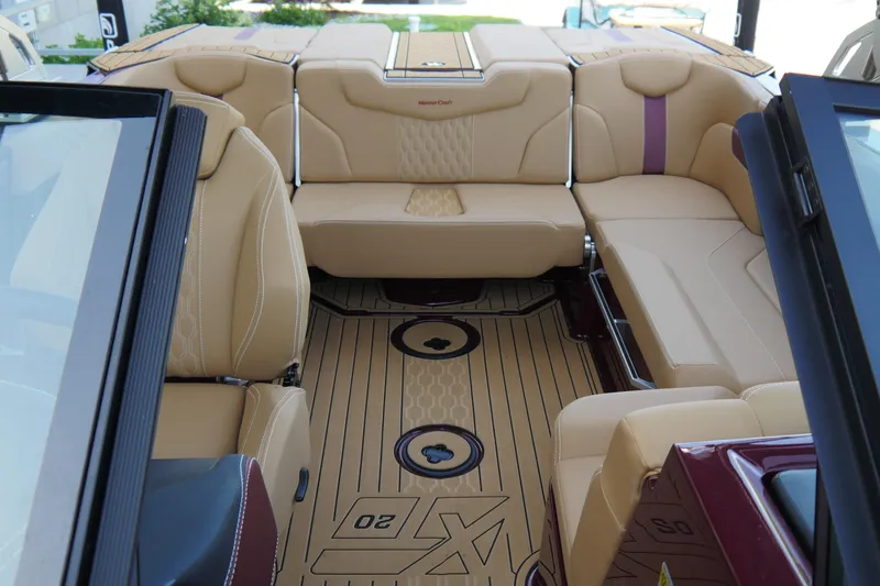 Slide: The Image of 2023 MasterCraft XT20 boat interior with tan leather seating and stylish flooring. - 9