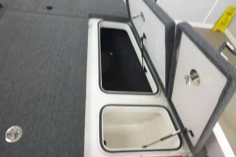 Slide: The Image of Open storage compartment in 2025 Ranger Z185 boat, showing interior and equipment. - 11