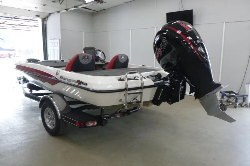 Slide: The Image of 2025 Ranger Z185 boat on trailer in showroom, featuring sleek design and red accents. - 2