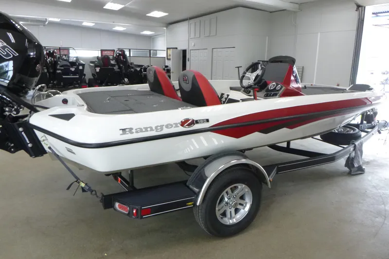 Slide: The Image of 2025 Ranger Z185 boat with powerful outboard motor in a garage setting. - 3