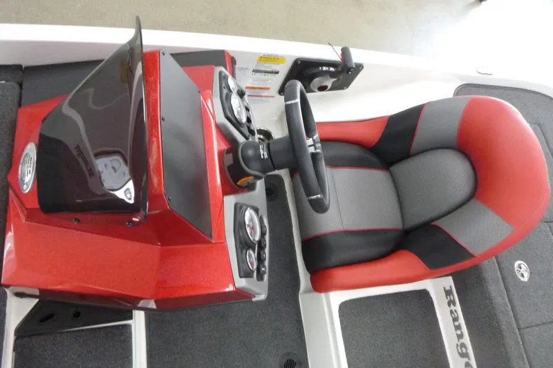 Slide: The Image of 2025 Ranger Z185 boat interior with red and gray seating, steering console, and storage compartments. - 6