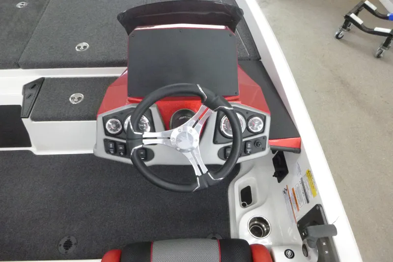 Slide: The Image of 2025 Ranger Z185 boat cockpit with red and black seat, steering wheel, and dashboard controls. - 7