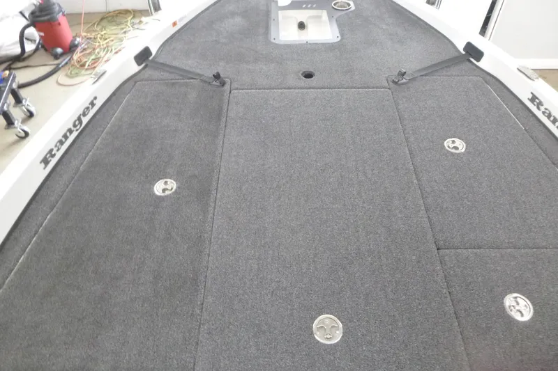 Slide: The Image of 2025 Ranger Z185 boat interior with red and gray seats, steering wheel, and dashboard. - 9