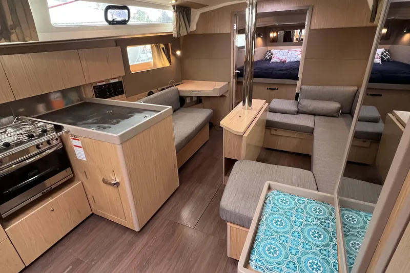 Slide: The Image of Interior of 2019 Beneteau Oceanis 41.1 yacht with modern kitchen and cozy seating area. - 3